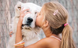 girl kissing a dog